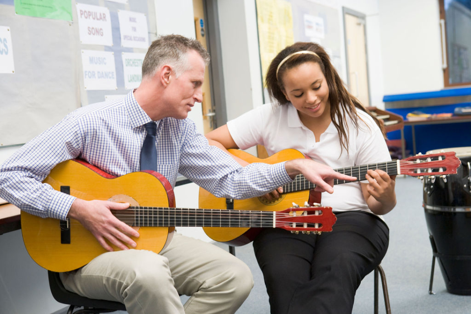 Music Teacher Teaches Student